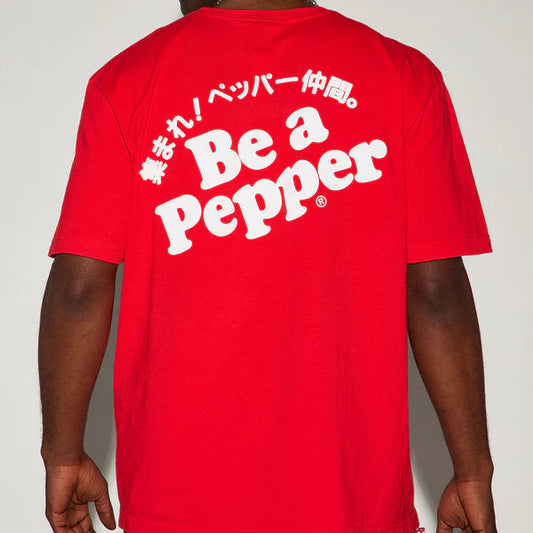 Person wearing a red t-shirt with 'Be a Pepper' text on the back against a white background