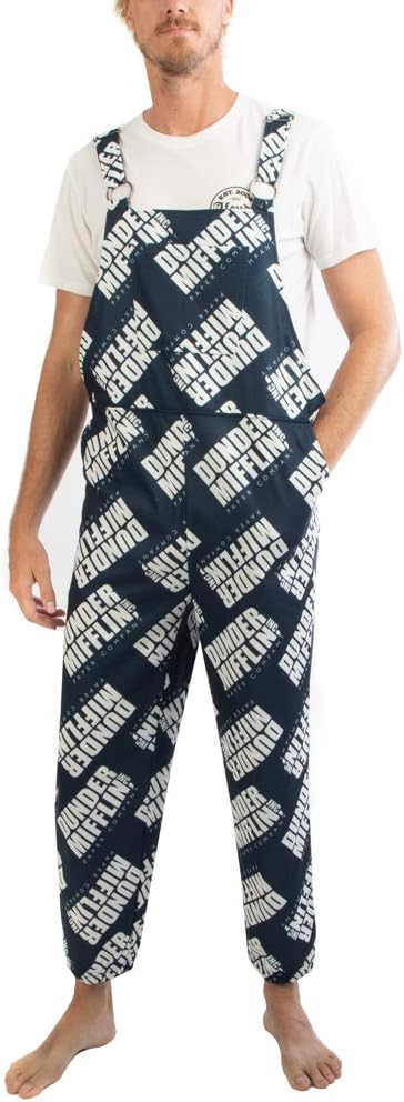 Person wearing navy blue overalls with white text pattern on a white background