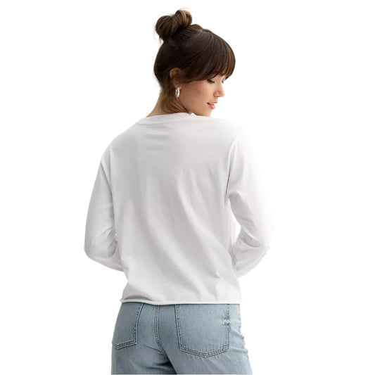 Person wearing a white sweatshirt and blue jeans on a light gray background