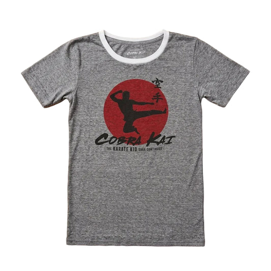 Gray t-shirt with Cobra Kai logo on a wooden surface
