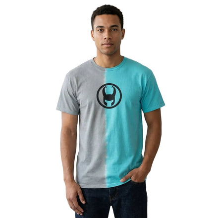 Man wearing a gray and blue t-shirt with a black logo in a living room setting