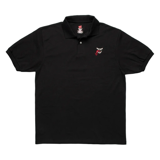 A black short-sleeve polo shirt laid flat on a light gray textured background, featuring a small embroidered red and white shark face logo on the left chest.