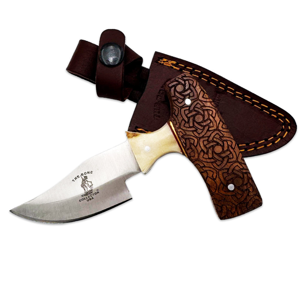 Bone Collector carved wood skinning knife with short blade and leather sheath, featuring detailed bone collector design.