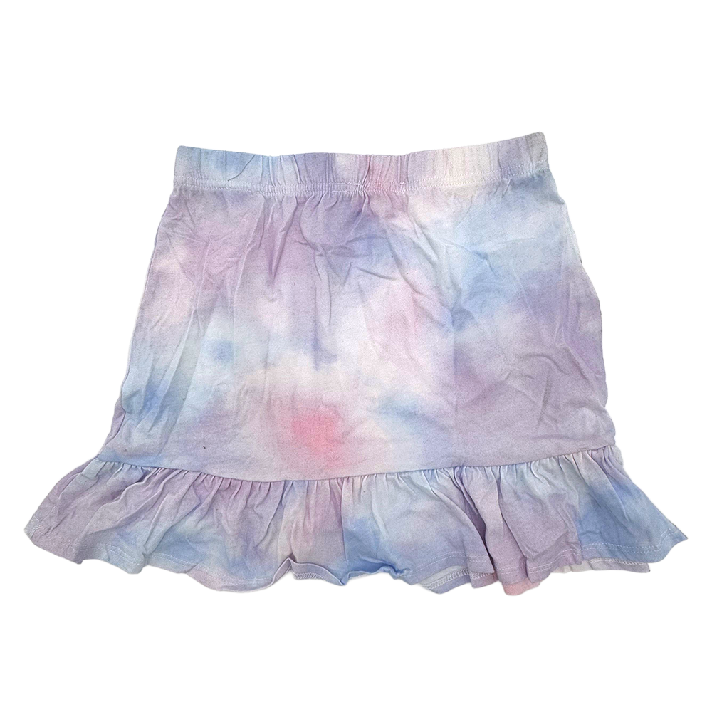 Girl wearing a colorful tie-dye Jojo Siwa skirt, styled with a casual shirt, in a bright and playful fashion.