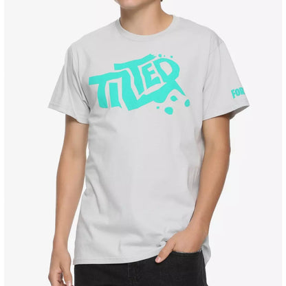 A young man wearing a light gray crewneck t-shirt with a bright turquoise 'TITLE' graphic on the chest and a small matching graphic on the sleeve, set against a plain light gray background.