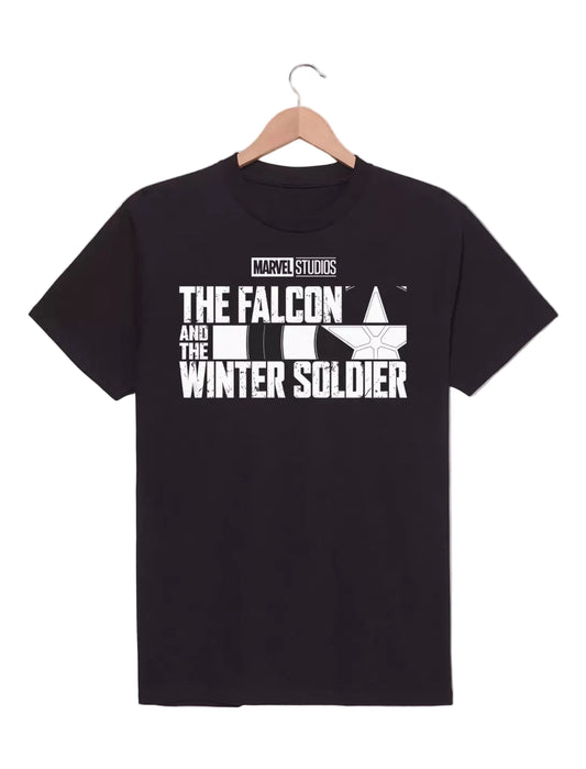 A black short-sleeve t-shirt hanging on a wooden hanger against a light gray background. The shirt features a white graphic print on the front with the text 'MARVEL STUDIOS THE FALCON AND THE WINTER SOLDIER' and a stylized Falcon emblem. 
