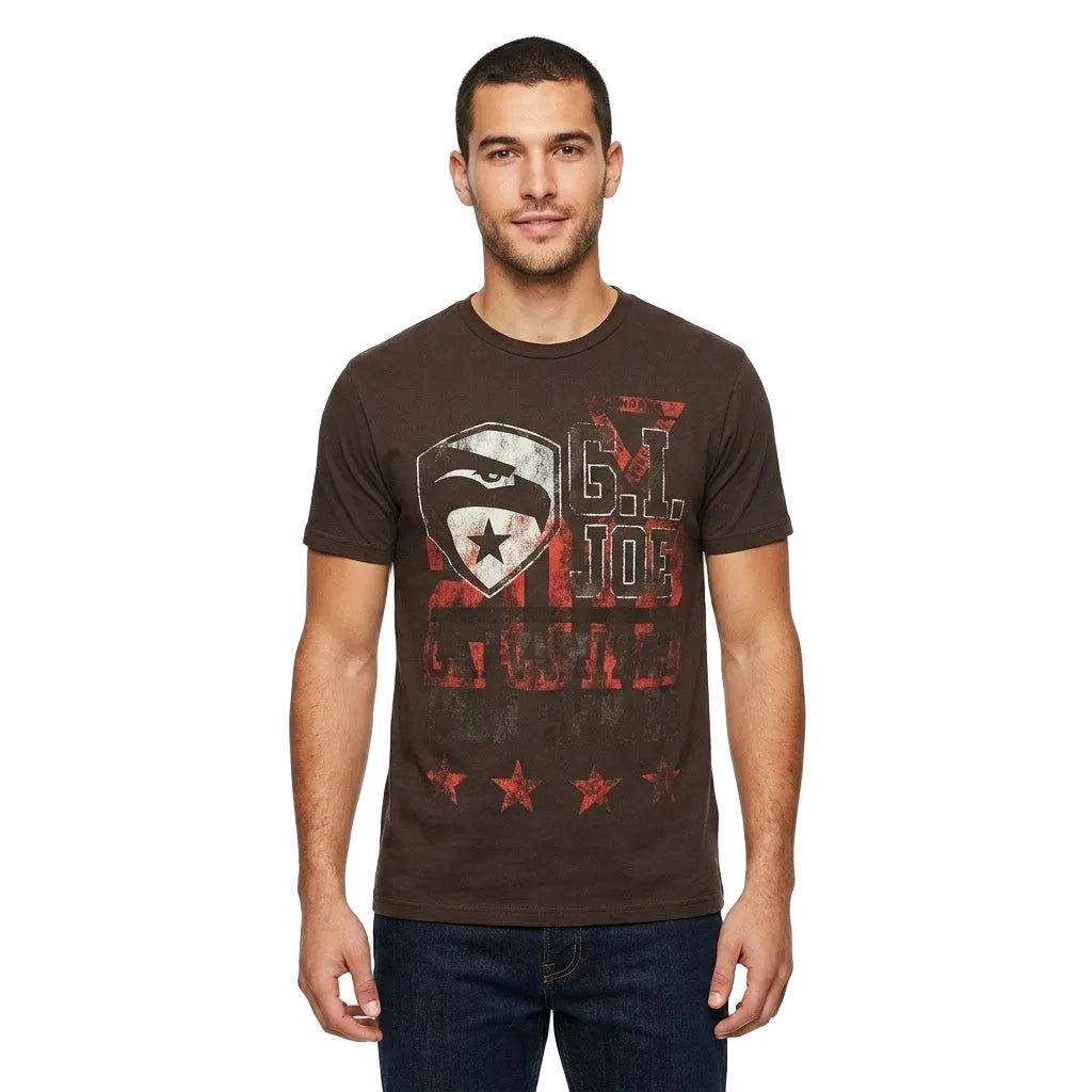 A man wearing a dark brown graphic t-shirt with a distressed red, white, and black design on the front, paired with dark blue jeans, photographed against a solid white background.