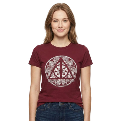A woman wearing a maroon short-sleeve t-shirt with a circular Deathly Hallows symbol graphic on the front, paired with blue jeans, against a plain white background.