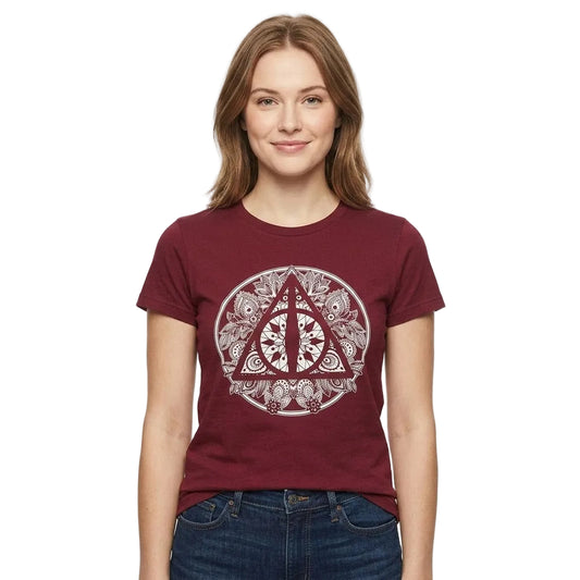 A woman wearing a maroon short-sleeve t-shirt with a circular Deathly Hallows symbol graphic on the front, paired with blue jeans, against a plain white background.