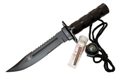 A black tactical combat knife with a serrated edge and a textured handle, shown alongside a black cord lanyard, a small clear case with brown sticks, and a black compass on a plain white background.
