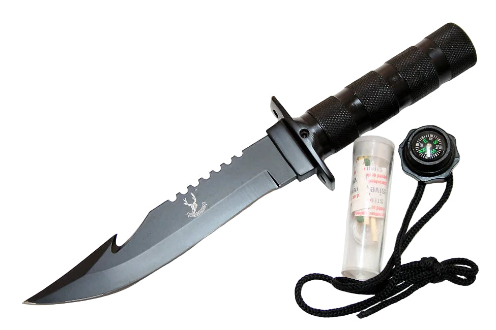 A black fixed-blade knife with a textured handle and a small deer head logo on the blade, shown alongside a black compass, a clear plastic fire starter tube, and a black cord on a plain white background.