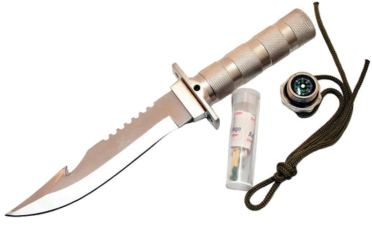 A tactical fixed-blade knife with a textured silver handle and a curved silver blade, shown alongside a small compass, a matchstick tube, and a paracord lanyard on a light off-white background.