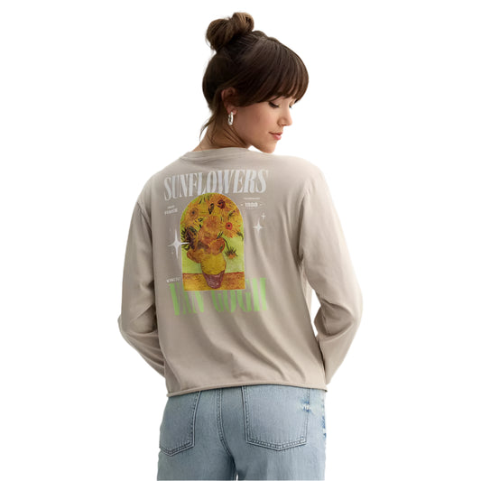 Person wearing a beige long-sleeve shirt with a sunflower graphic and text on the back.