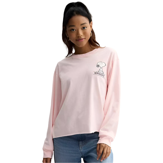 Person wearing a pink sweatshirt with a small logo on a plain background