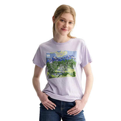 A woman modeling a light purple crewneck t-shirt with a colorful Van Gogh style landscape graphic on the front, paired with dark blue jeans, against a plain light gray background.