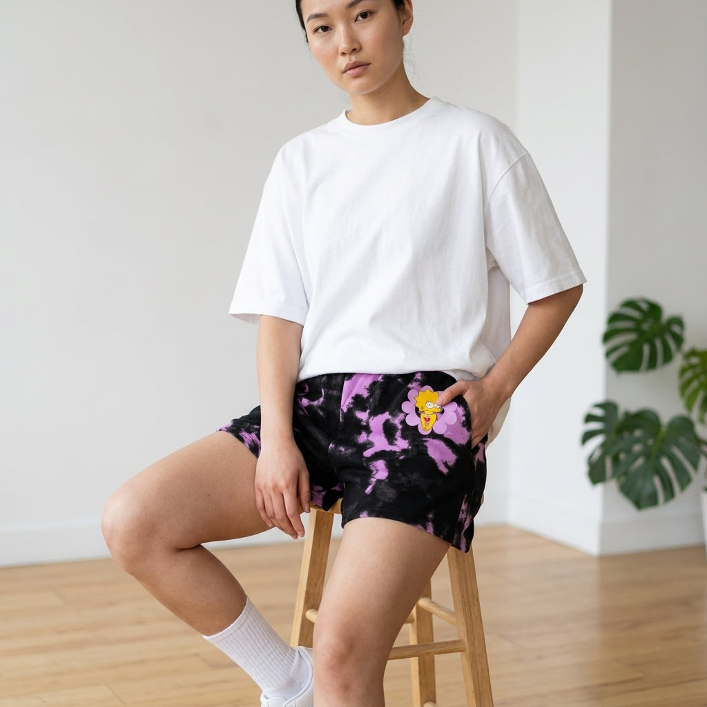 Women’s black and pink tie-dye The Simpsons Lisa flower graphic sweat shorts by Mad Engine, featuring colorful cartoon character print.