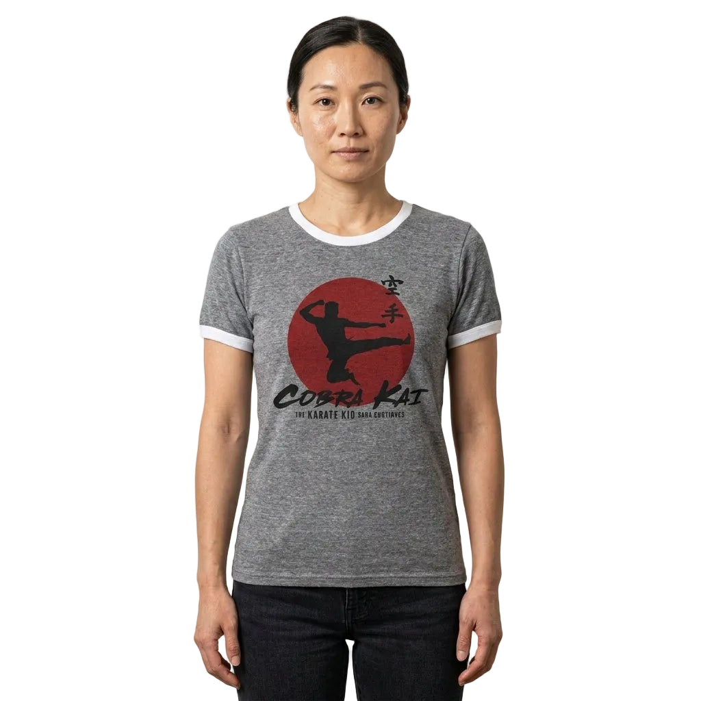 Person wearing a gray t-shirt with a 'Cobra Kai' logo on a plain background