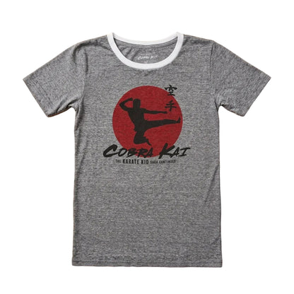 Gray t-shirt with Cobra Kai logo on a wooden surface
