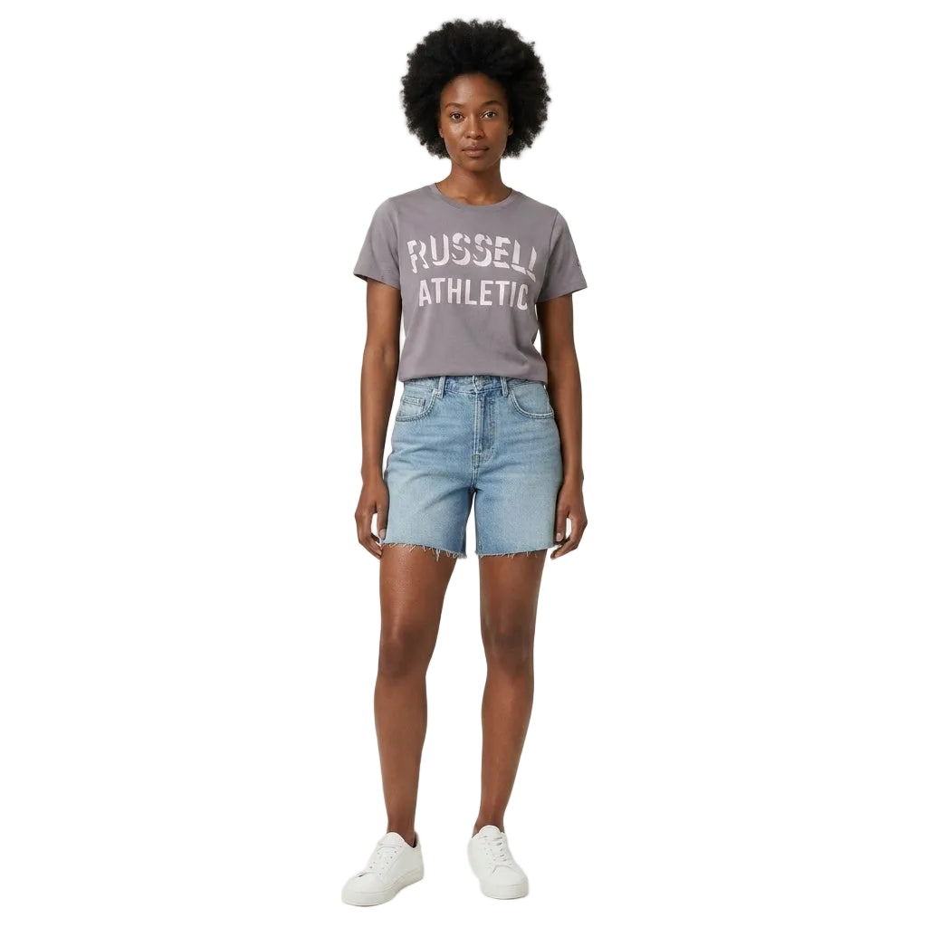 Person wearing a gray 'Russell Athletic' t-shirt and light blue denim shorts on a white background