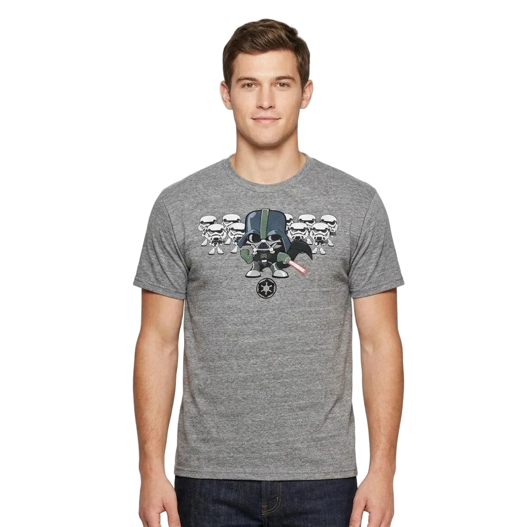 A man wearing a heather gray crewneck t-shirt with a graphic print of Star Wars characters (Stormtroopers and a Bofarress) on the chest, paired with dark blue jeans, against a light gray studio background.