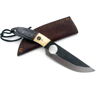 A fixed-blade knife with a dark wood handle, a circular cutout in the blade, and a stamped 'Kershaw' logo, shown resting on a brown leather sheath against a white background.