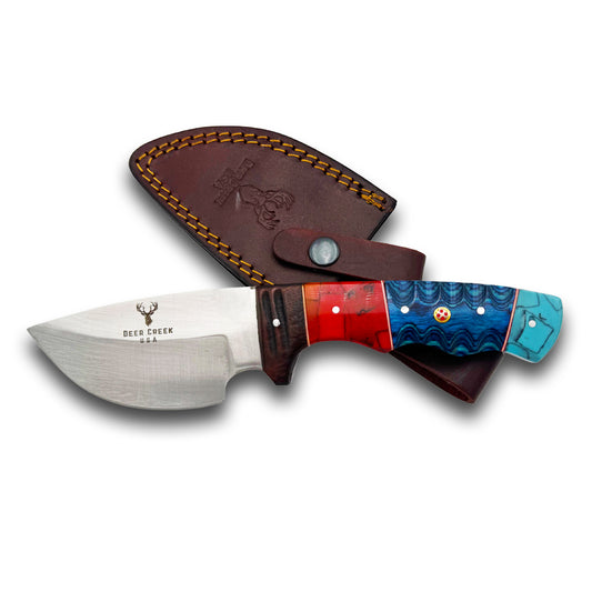 Knife with multicolored handle and leather sheath on a white background