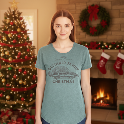 Woman wearing a 'Griswald Family Christmas' t-shirt in a festive living room with a Christmas tree and stockings.