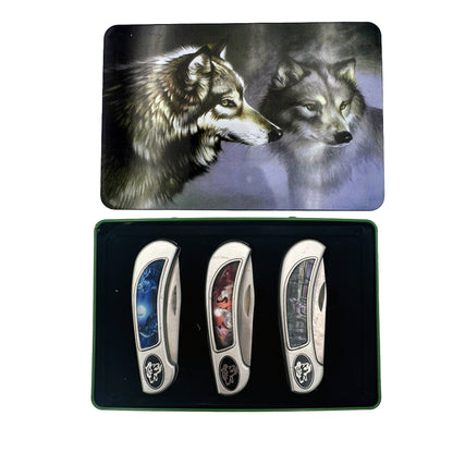 Display set of three Rex Distributor, Inc. Wolf knives in a tin box gift set, featuring sleek stainless steel blades and ergonomic handles.