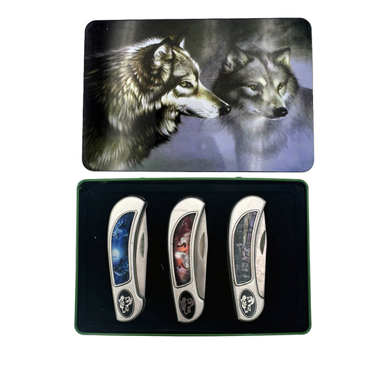 Display set of three Rex Distributor, Inc. Wolf knives in a tin box gift set, featuring sleek stainless steel blades and ergonomic handles.