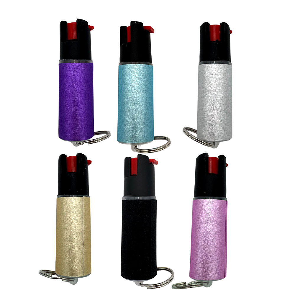 Six pepper spray canisters in different colors on a white background