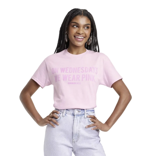 Women's pink graphic T-shirt by Mad Engine featuring "On Wednesdays We Wear Pink" from Mean Girls, short sleeve design.