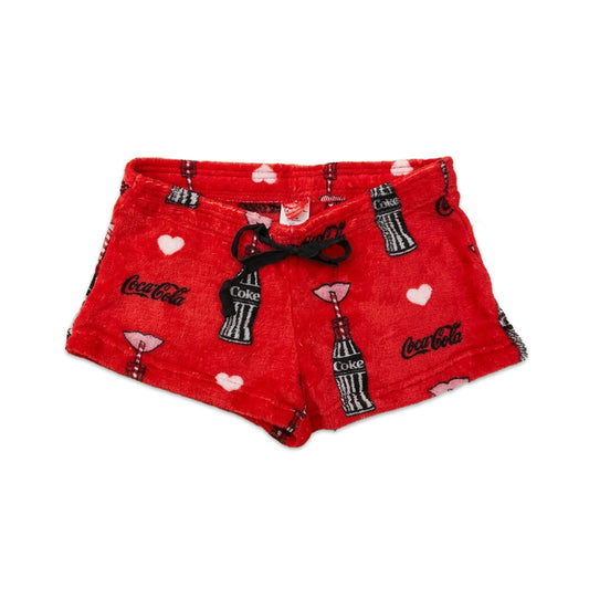 Women's red Coca-Cola Love fleece shorts featuring a relaxed fit and Coca-Cola logo design, from Bioworld sleepwear collection.