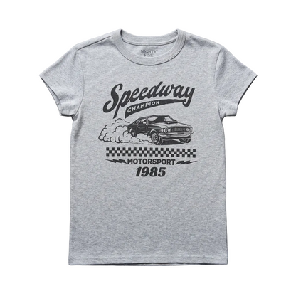A light heather gray short-sleeve t-shirt with a black graphic print featuring a race car, smoke, a checkered flag, and the text 'Speedway Champion Motorsport 1985', laid flat on a dark gray textured surface.