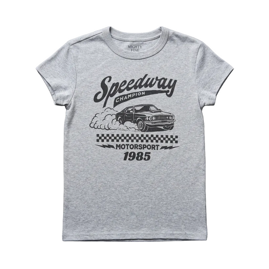 A light heather gray short-sleeve t-shirt with a black graphic print featuring a race car, smoke, a checkered flag, and the text 'Speedway Champion Motorsport 1985', laid flat on a dark gray textured surface.