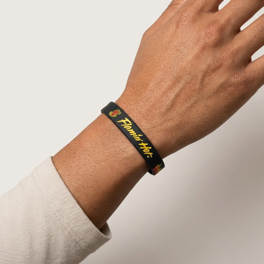Pair of Cheetos Flamin' Hot rubber bracelets in a 2-pack, colorful accessories from Mad Engine featuring Cheetos branding.