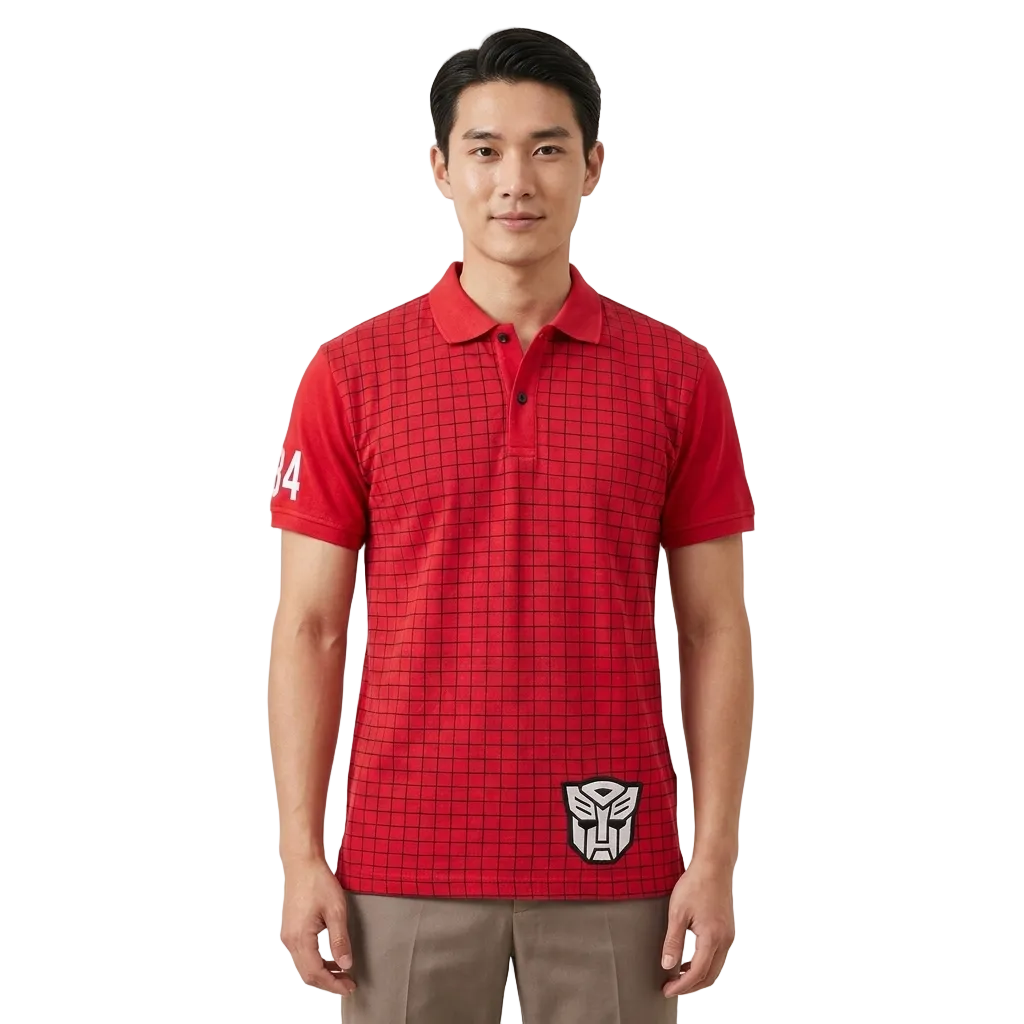 A man wearing a red short-sleeve polo shirt with a black grid pattern, featuring a white Transformers logo on the lower left hem and a white number '4' on the right sleeve, paired with khaki pants against a light gray background.