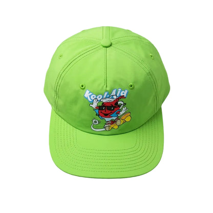 A bright lime green baseball cap featuring a cartoon graphic of a red character on a skateboard with the text 'Kool-Aid' in blue, displayed on a textured gray background.
