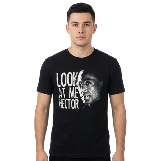 A man wearing a black short-sleeve graphic t-shirt with a white print of a portrait and the text 'LOOK AT ME, HECTOR' on the front, set against a plain white background.