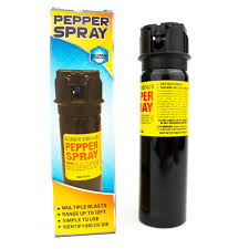 Pepper spray with packaging displaying warning labels and brand name.