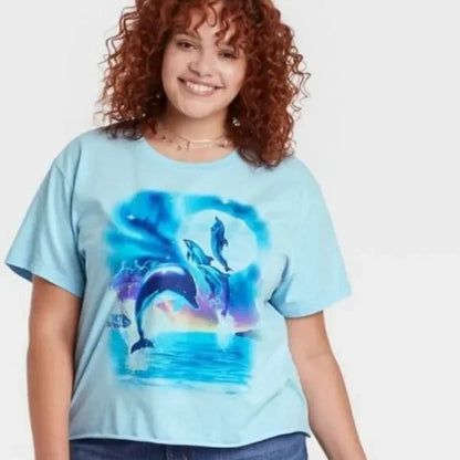 Women's Mighty Fine Dolphins short sleeve cropped graphic T-shirt featuring colorful dolphin illustrations on soft fabric.