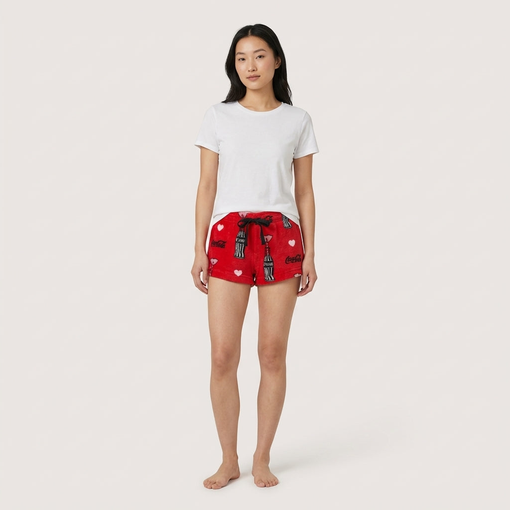 Red Coca-Cola Love fleece shorts for women by Bioworld, featuring a cozy sleepwear design with Coca-Cola branding.