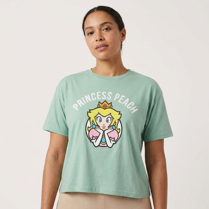 Light green Princess Peach Super Mario graphic T-shirt for women by Mad Engine, featuring a colorful Mario character design.