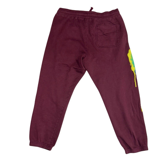 Maroon sweatpants with a colorful design on a white background